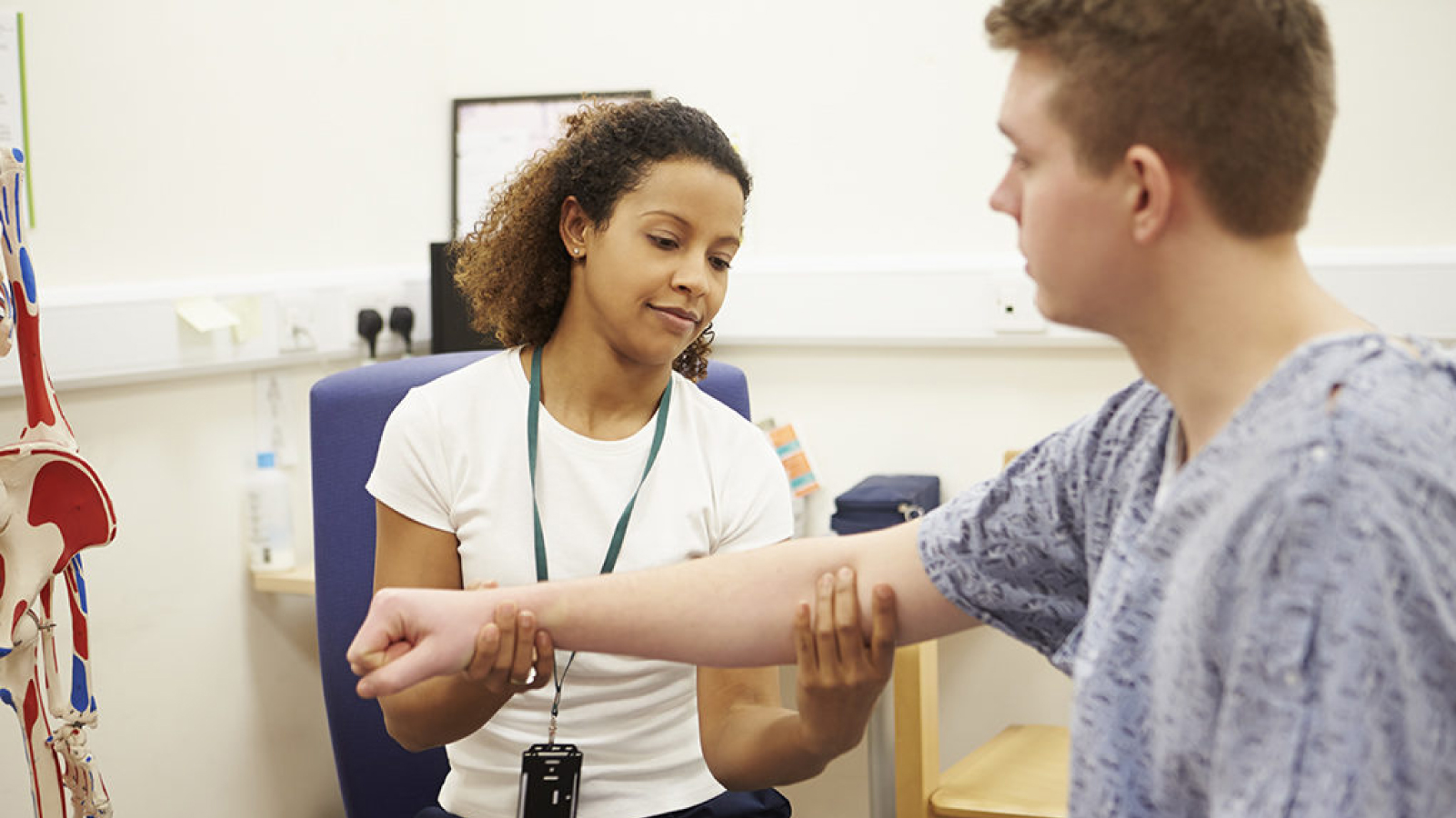 Occupational Therapy Assistant student practices measuring muscle strength on fellow student