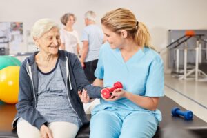 occupational therapy assistant helping with hand mobility