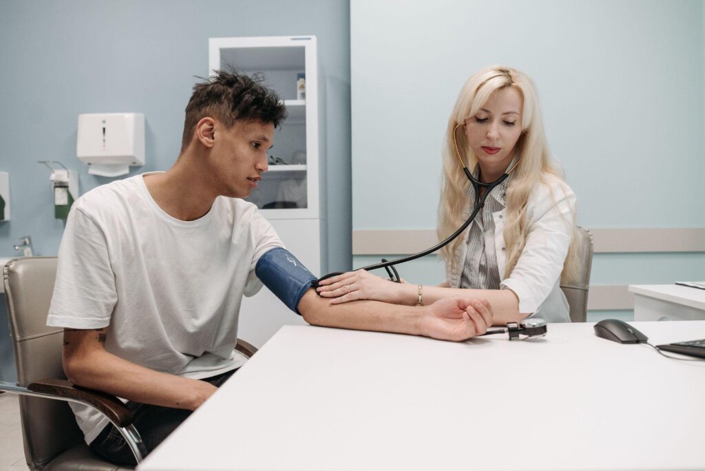 Student practicing phlebotomy as a Patient Care Technician in a campus lab